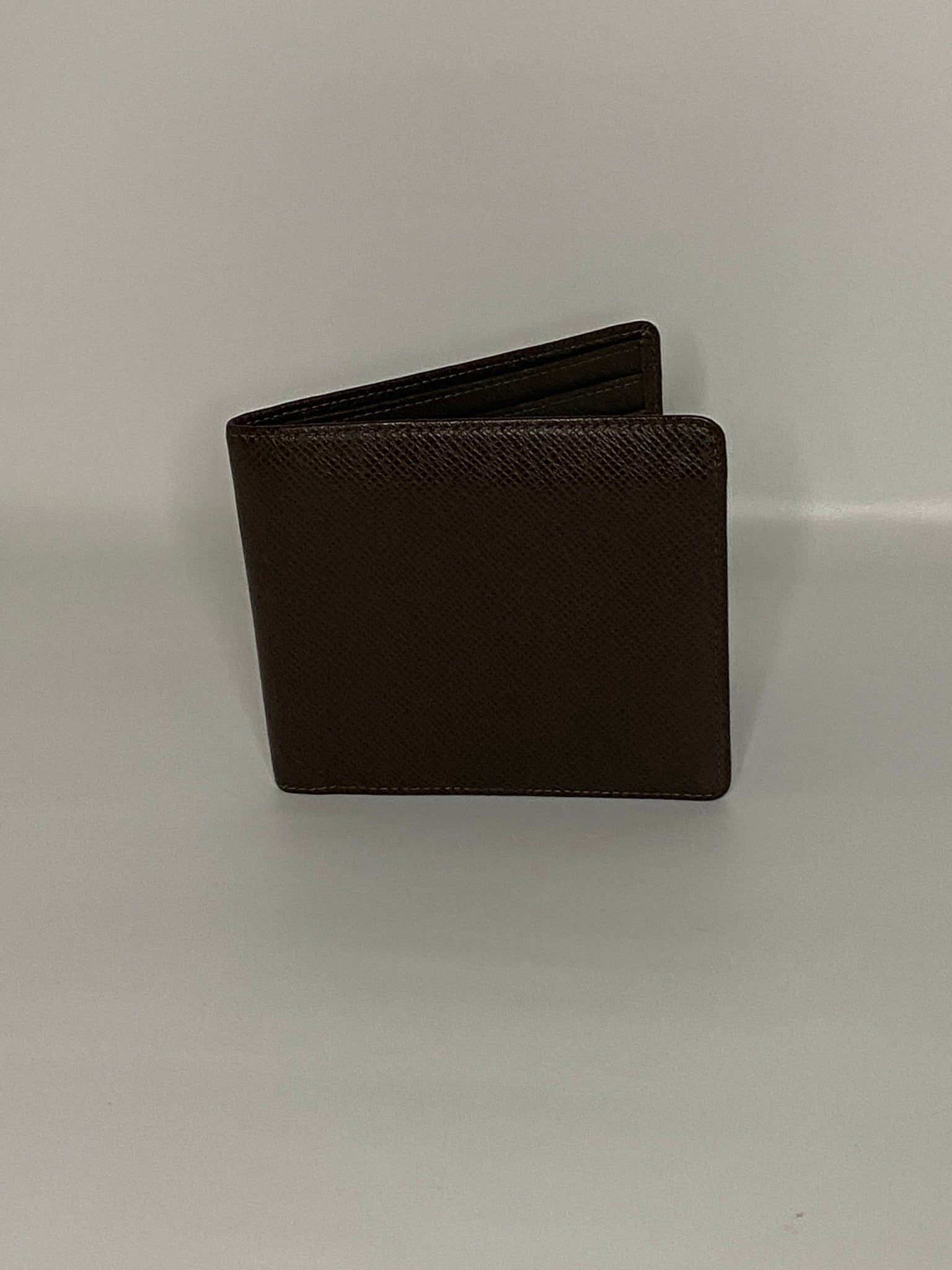 Authenticity Guaranteed - Louis Vuitton Taiga Bifold Wallet